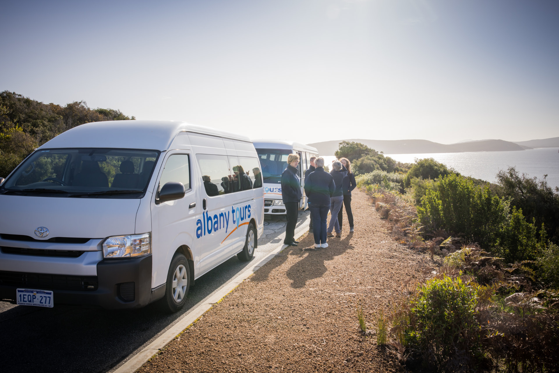 Albany Tours guides gathered beside their tour vehicles on the Great Southern coast