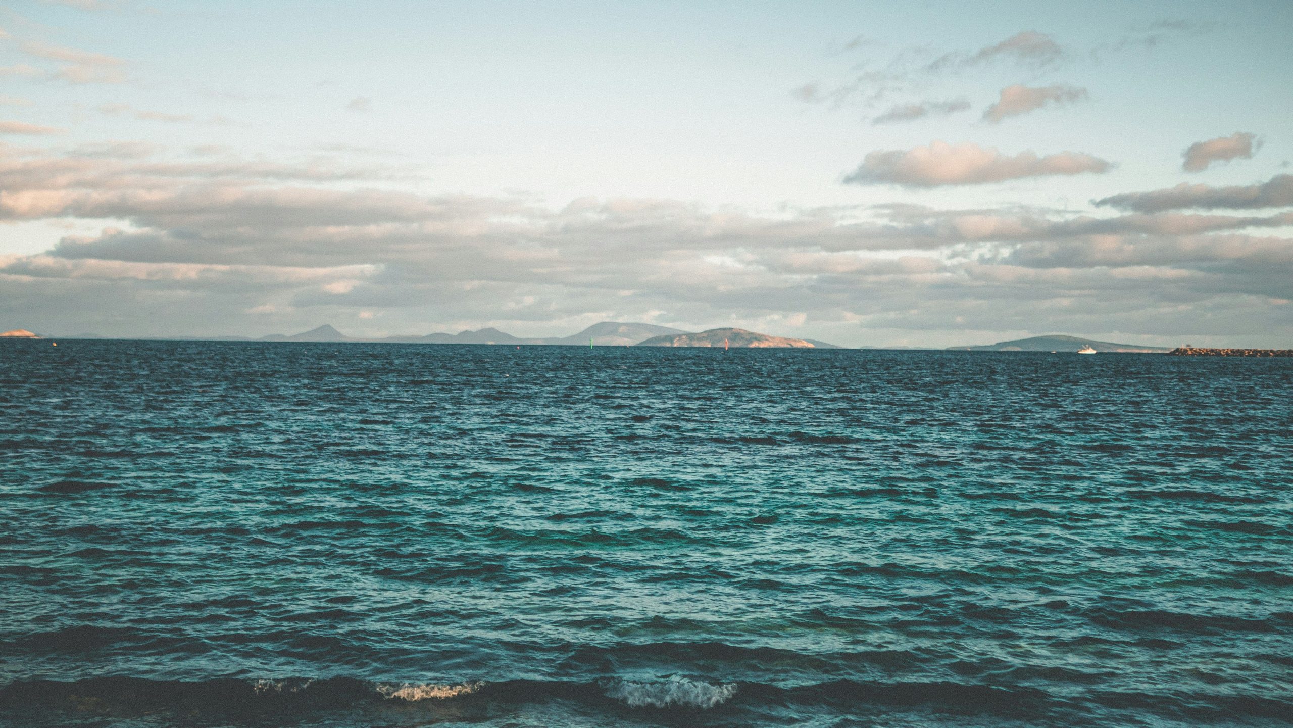 Looking out across the deep blue waters of King George Sound towards distant islands, a classic scenic view when visiting Albany WA.