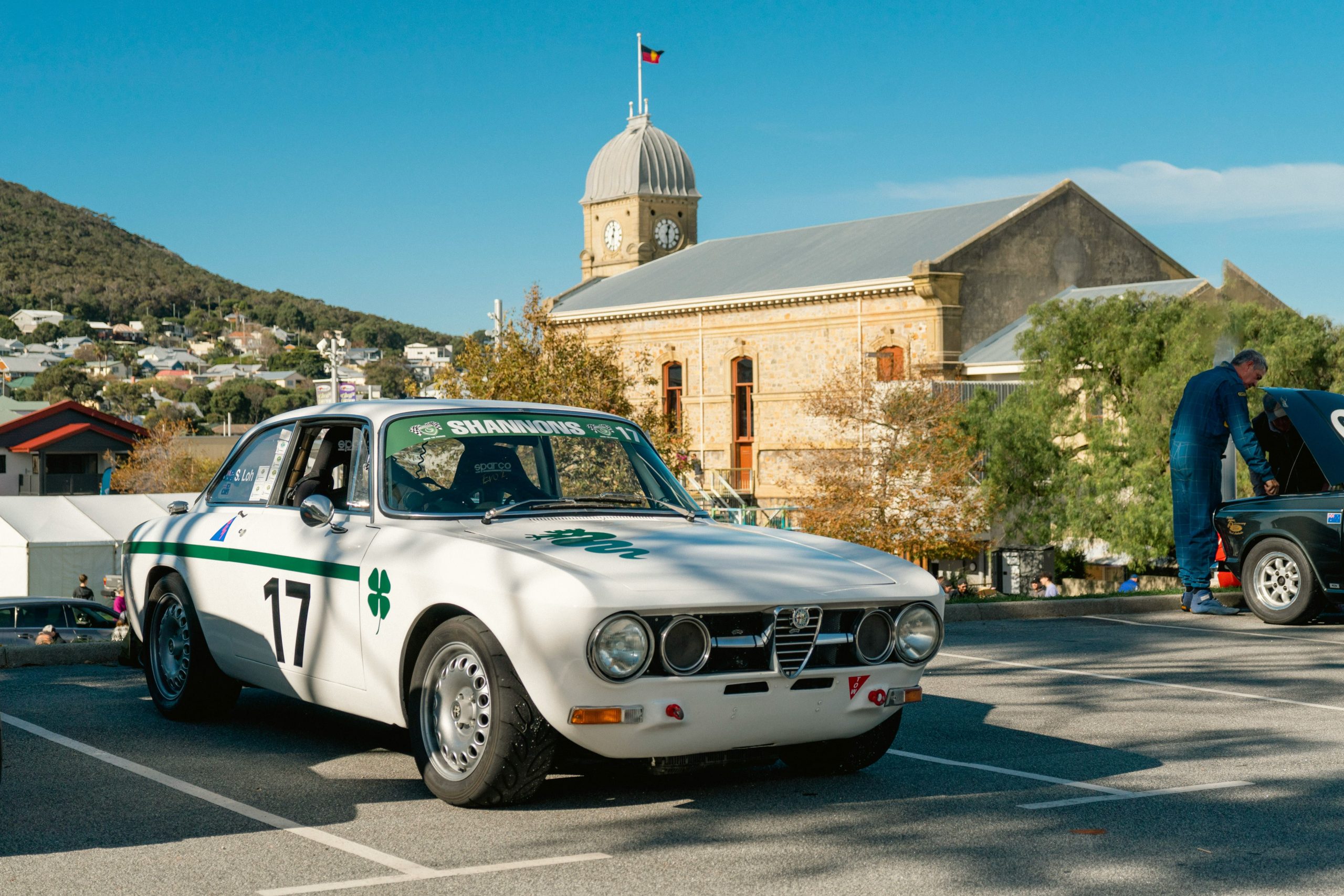 A vintage white Alfa Romeo race car parked in front of the historic Albany Town Hall during the annual Albany Classic motor festival.